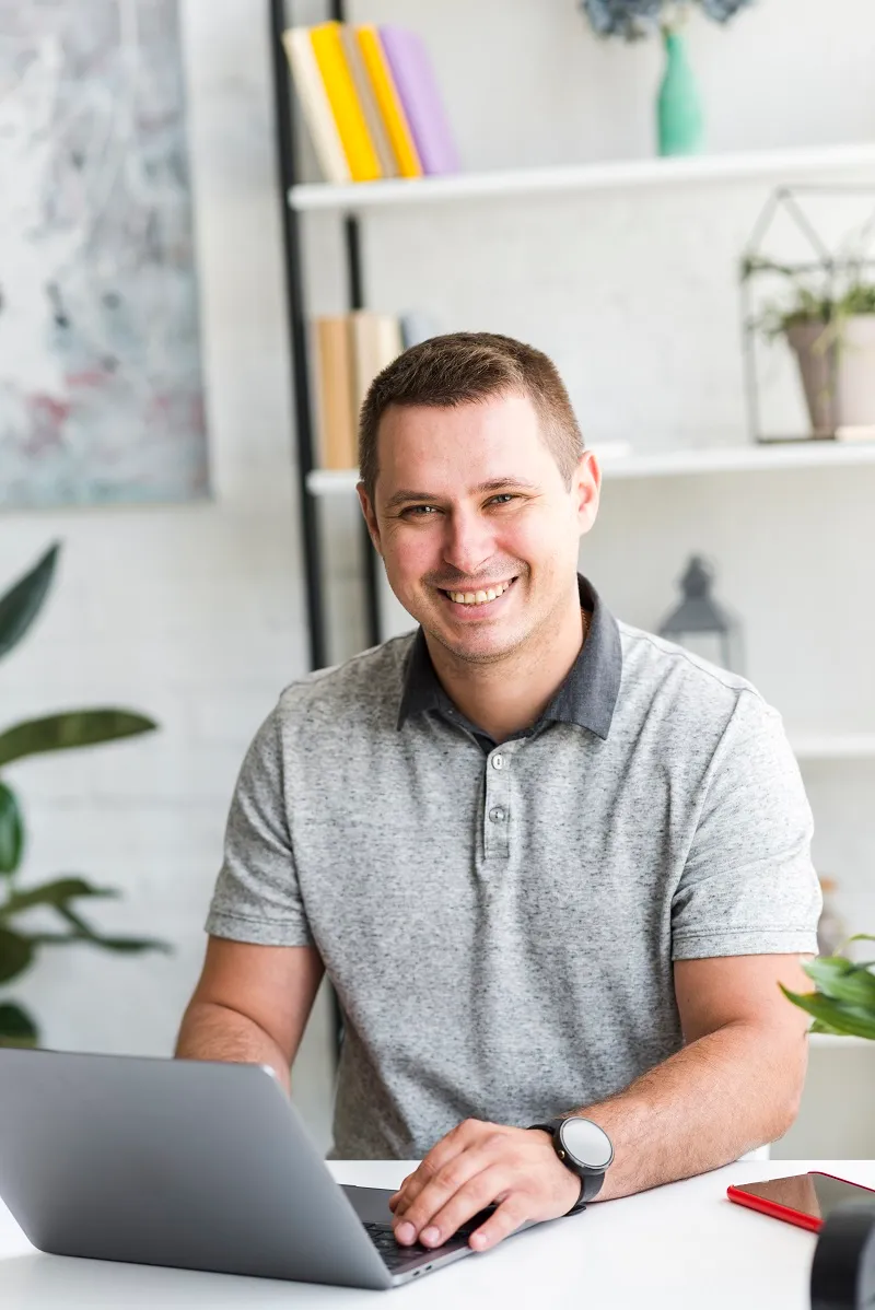 Happy professional working on a laptop, representing Duskbyte’s focus on innovative web development and cloud-based solutions.